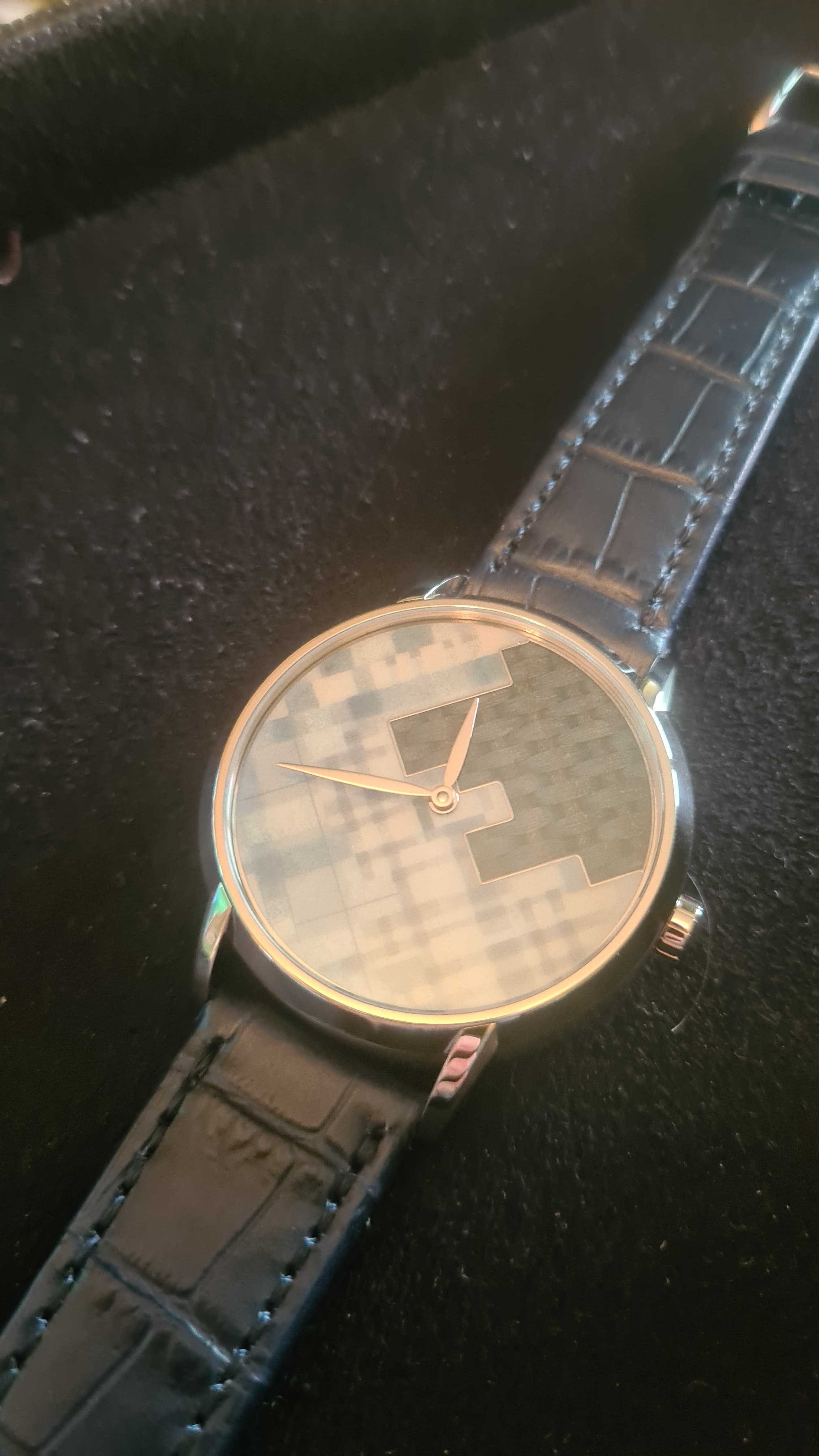 unique piece TAOS watch swith blue enamel dial using differnt techniques to mimic fabric effect in white gold case with gold hands and dark blue leather strap