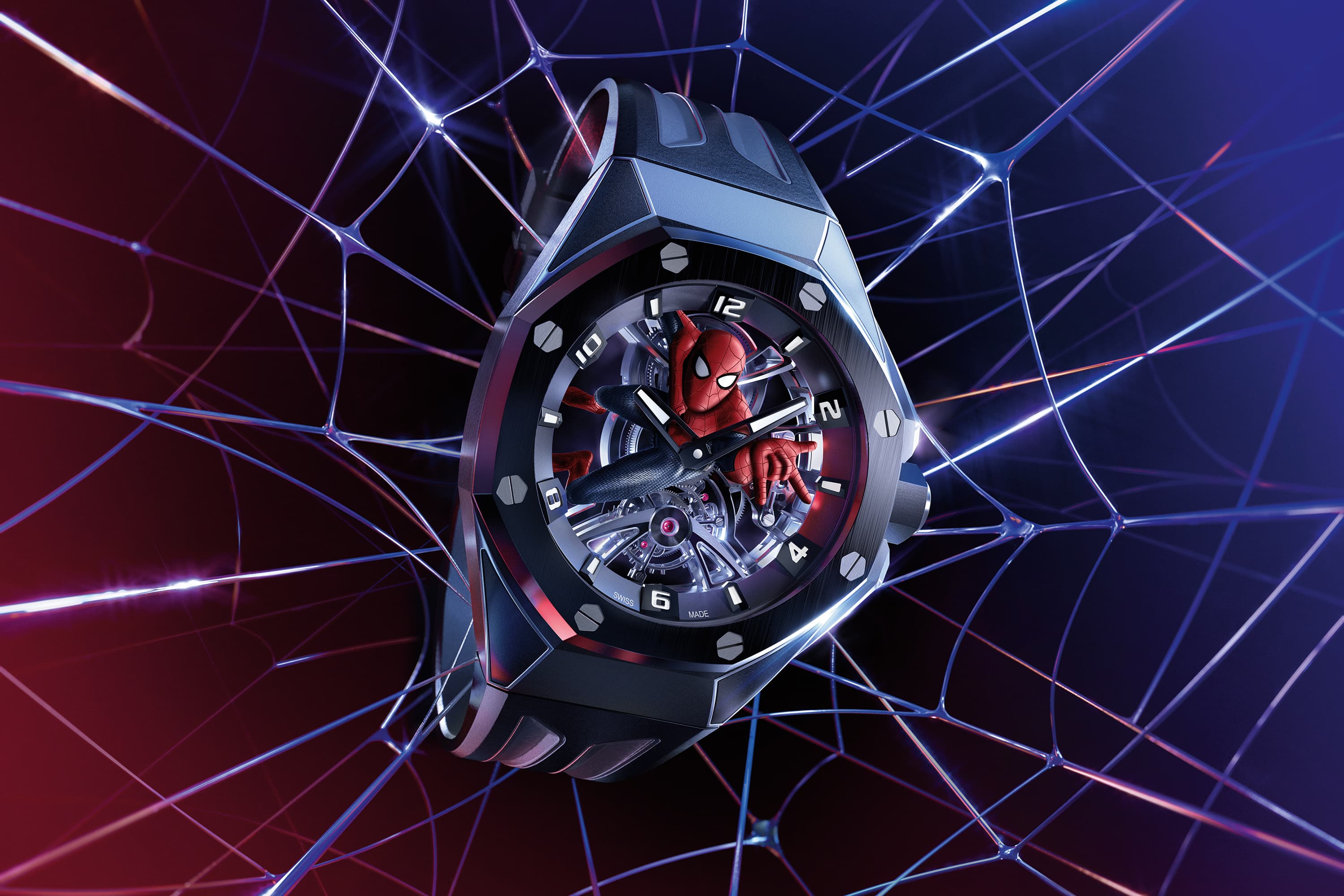 a dark blue cermaic watch on a dark rubber strap with spiderman on the dial and a web background