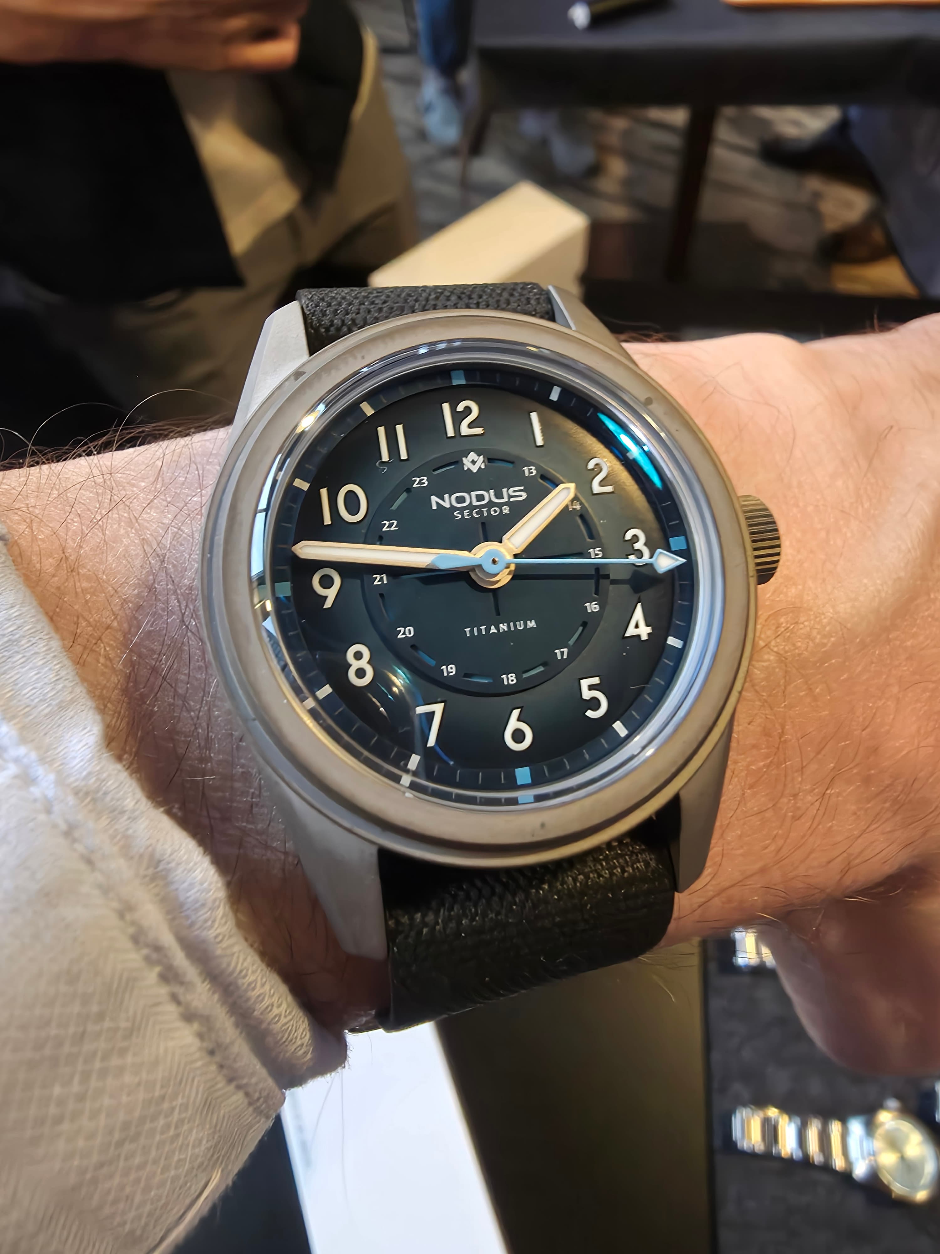 a titanium cased field watch from Nodus with a blue dial and white hands
