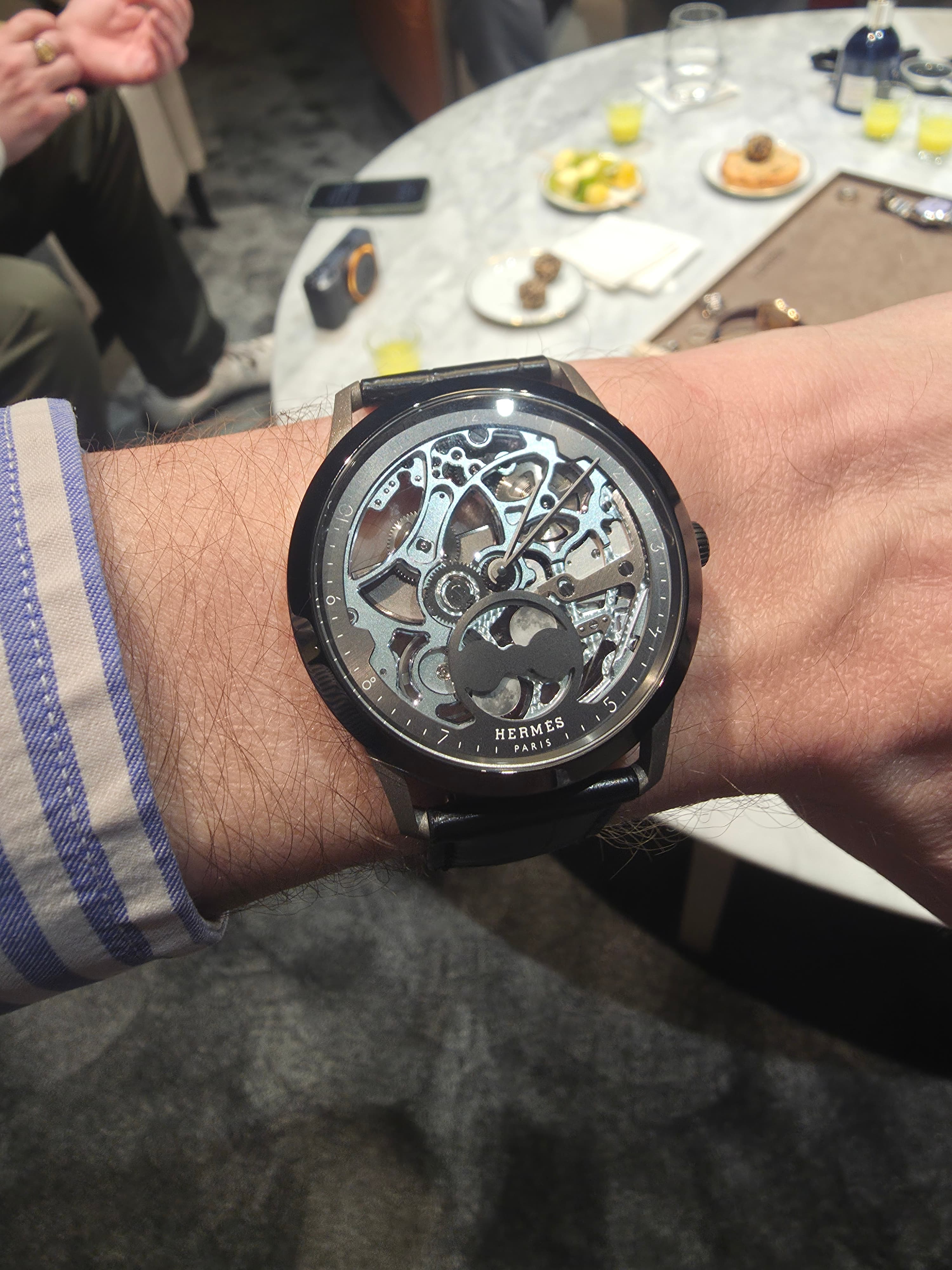 a black cased and blue dialed skeletonised Hermes Slim Dress Watch in titanium