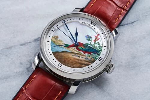 a stell RGM watch with a hand painted dial featuring a tropical bird drinking from a stream