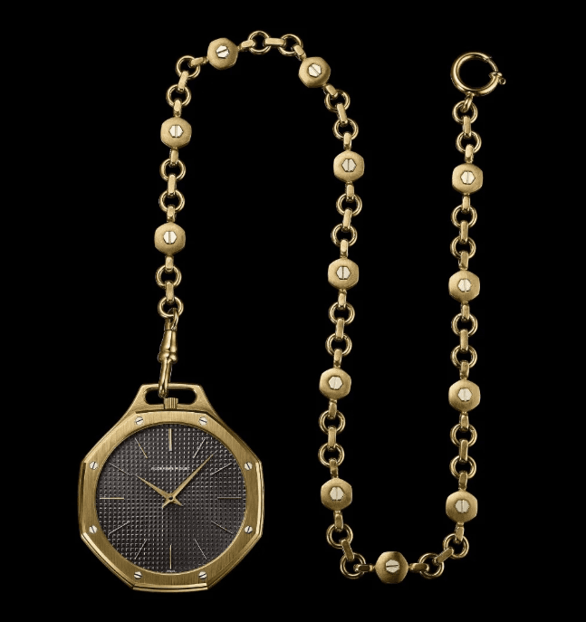 a gold Audemars piguet royal oak pocket watch on a gold chain with grey dial on a black background