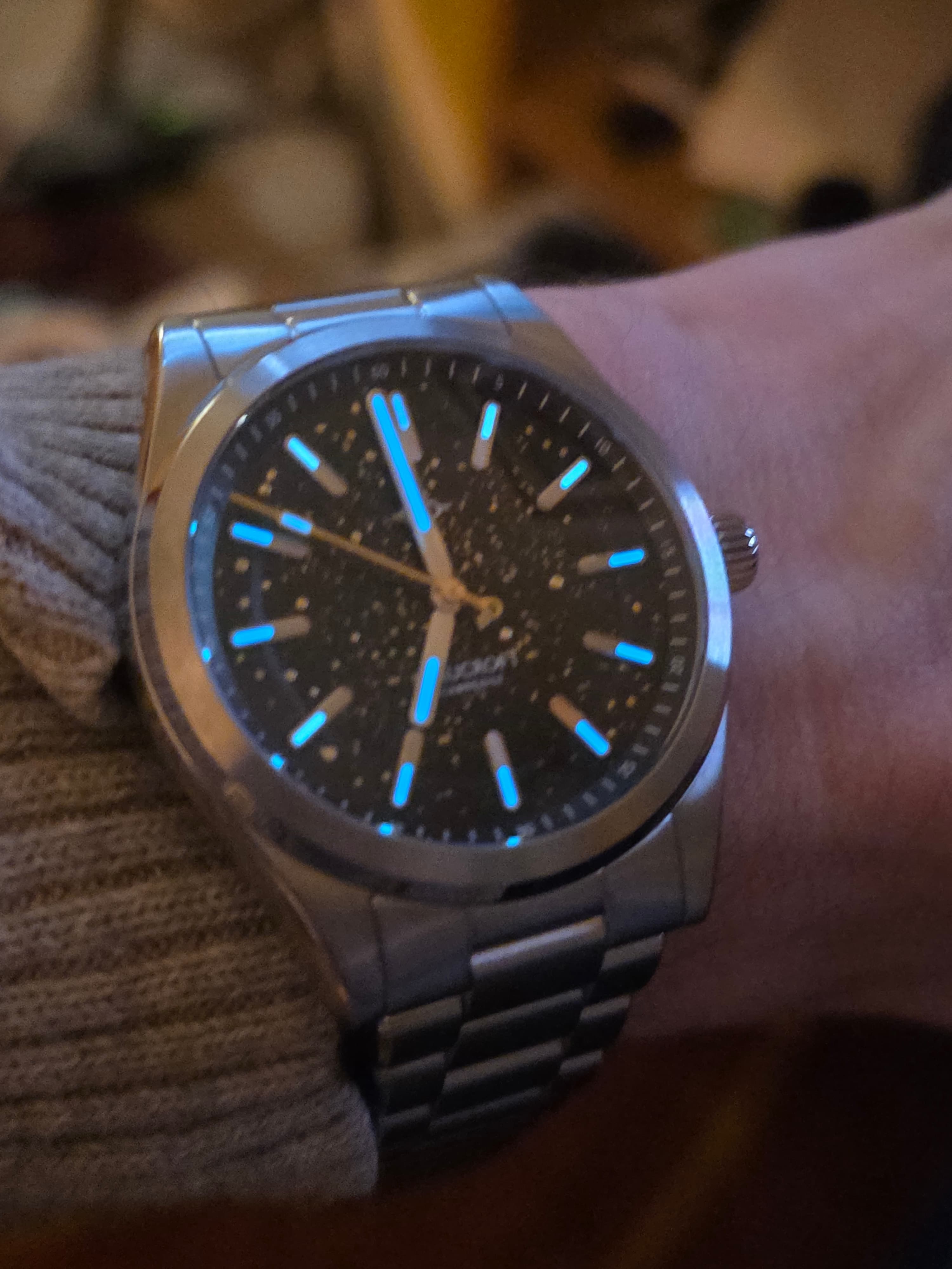dark shot of the beaucroft element watch collectors club edition with the luminous plots in blue glowing brightly including on the seconds hand