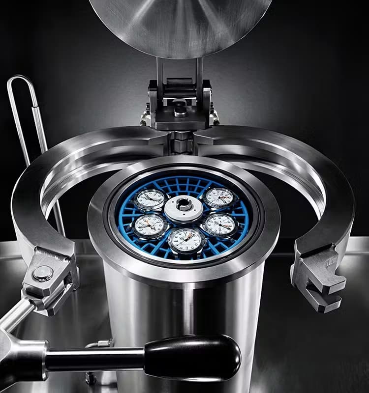 Rolex Explorer II watches in one of the machines they use to test waterproofing and pressure resistance in their Quality Control Process.